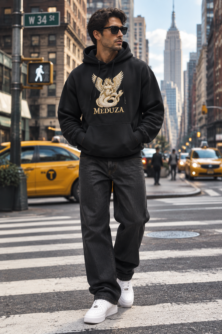 Model wearing the black Meduza Gilded Seraph Hoodie on a New York City street